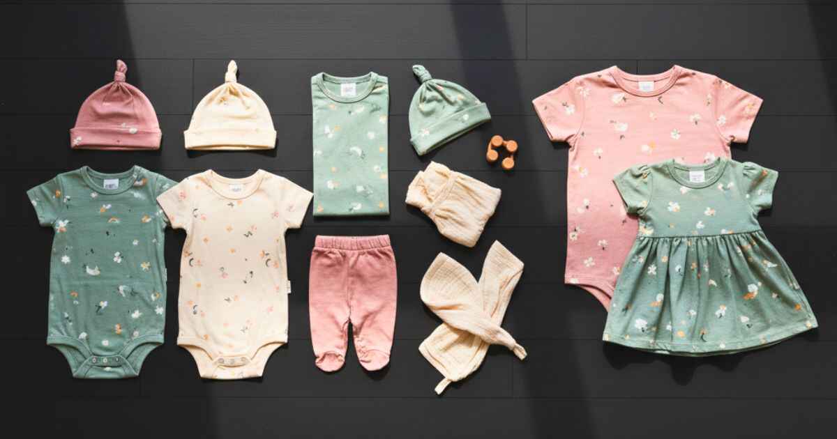 Rylee and Cru family wardrobe flatlay with soft pastel kidswear in dark background